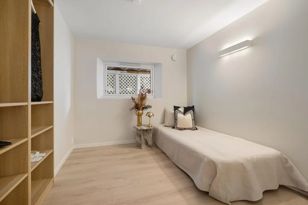 Simple room with a bed and shelves